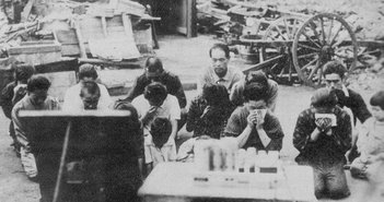 1024px-Japanese_civilians_listening_to_the_surrender_broadcast