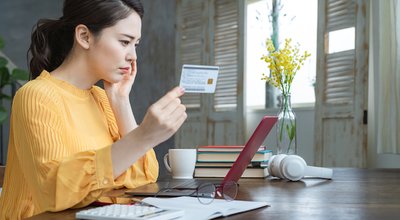Attractive asian woman using a credit card. Online shopping.