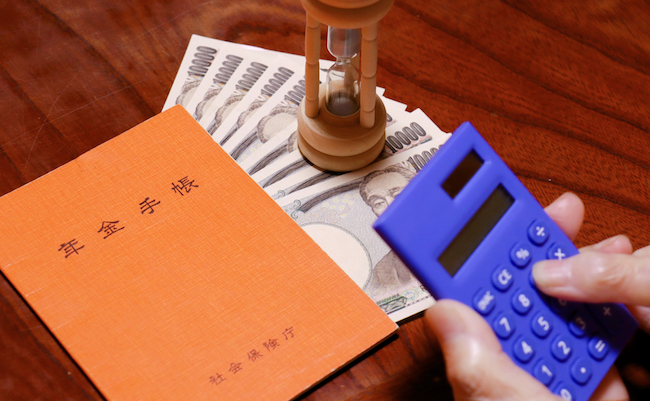 An,Orange,Notebook,And,Elderly,Hands.,Translation:,Pension,Notebook.