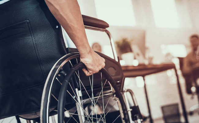Close,Up.,Disabled,Man,On,Wheelchair,In,Office.,Disabled,Young