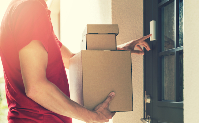 Delivery,Service,Courier,Ringing,The,House,Doorbell,With,Boxes,In