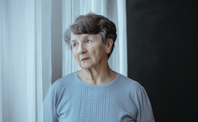 Worried,Grandmother,With,Alzheimer's,Disease,Isolated,Looking,Through,Window,In