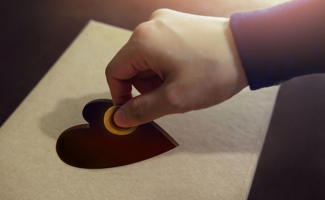 Donation,Concept.,Hand,Putting,Money,Coin,Into,A,Heart,Shape