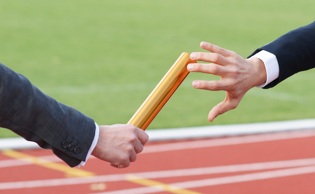 Businessman,Passing,Baton,In,Relay,Race