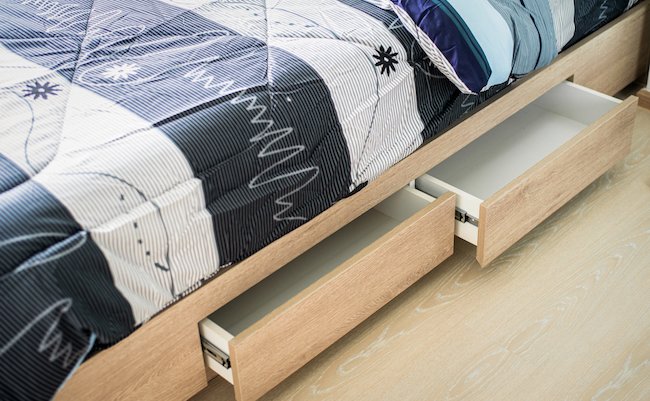 Close,Up,Shot,Of,Opened,Drawer,Under,Modern,Bed,In
