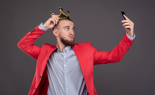Young,Bearded,Handsome,Man,In,Gold,Crown,Taking,Selfie,Looking