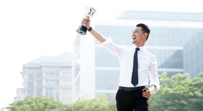 Young,Asian,Businessman,Holding,Trophy,Awards,After,Successful,With,His