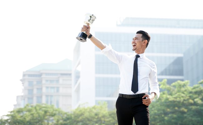 Young,Asian,Businessman,Holding,Trophy,Awards,After,Successful,With,His