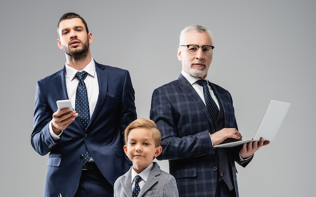 Smiling,Boy,With,Newspaper,Looking,At,Camera,Near,Dad,And