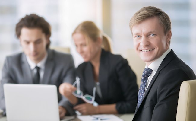 Portrait,Of,Businessman,With,Subordinates,At,The,Background.,Group,Of