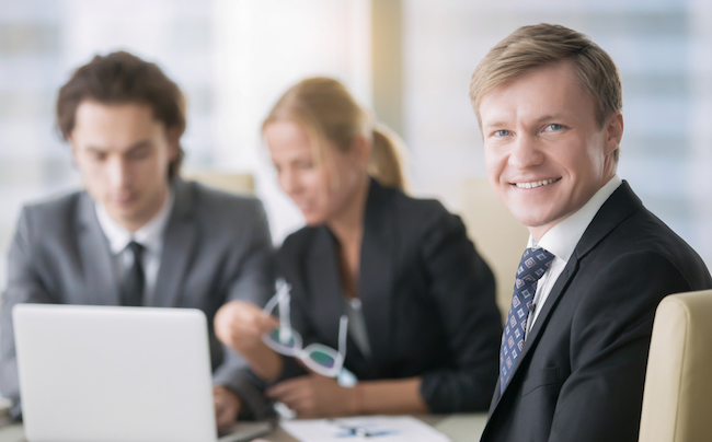 Portrait,Of,Businessman,With,Subordinates,At,The,Background.,Group,Of