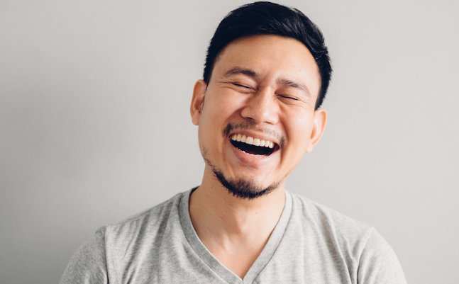 Headshot,Photo,Of,Asian,Man,With,Laugh,Face.,On,Grey