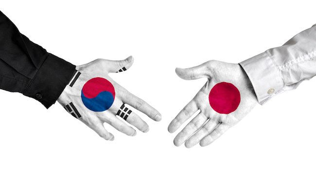South,Korea,And,Japan,Leaders,Shaking,Hands,On,A,Deal