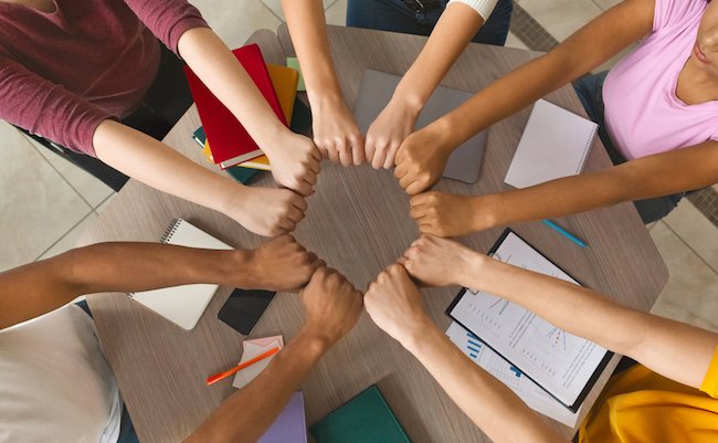 Multiracial,Students,Joining,Hands,Together,,Preparing,Common,Academic,Project,,Top