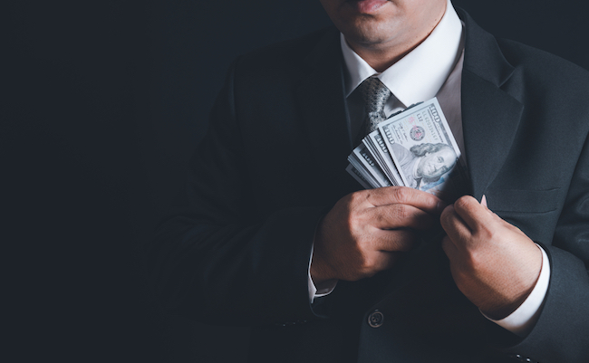 Man,Putting,Bribe,Money,Into,Pocket,On,Black,Background,,Concept