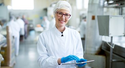 Young,Joyful,Beautiful,Female,Worker,In,Sterile,Cloths,Holding,A