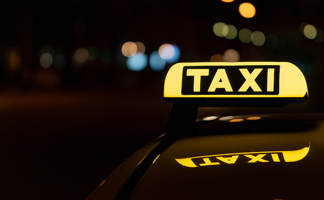 A,Close-up,Shot,Of,A,Taxi,Sign,In,The,Night