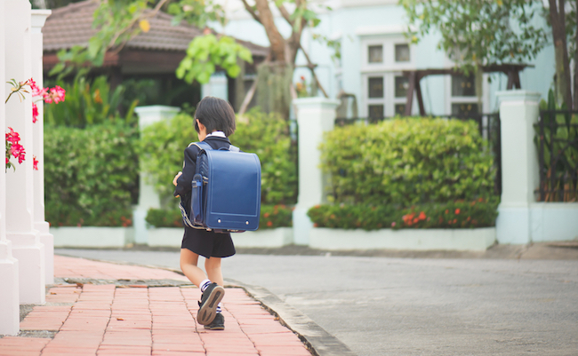 Asian student with backpack outdoors,back to school concept
