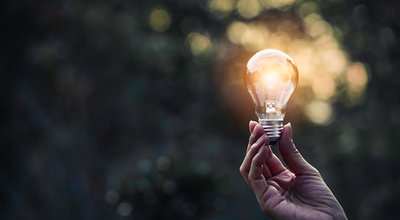 Innovation and energy concept of hand hold a light bulb and copy space for insert text.