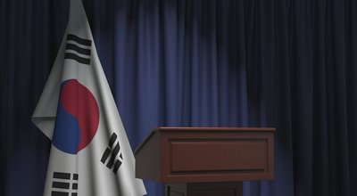 Flag of South Korea and speaker podium tribune. Political event or statement related conceptual 3D rendering