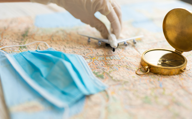 travel agency theme. Planning trip during virus covid corona quarantine with personal protection items face mask and medical gloves. Plane is about to take off. Map, compass, face mask, Tourism