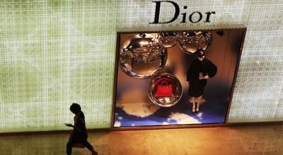 NANJING CHINA-September 8, 2013: pedestrians walk past a billboard at the Dior store in Nanjing, Xinjiekou. China has become the world's largest consumer market for luxury goods.