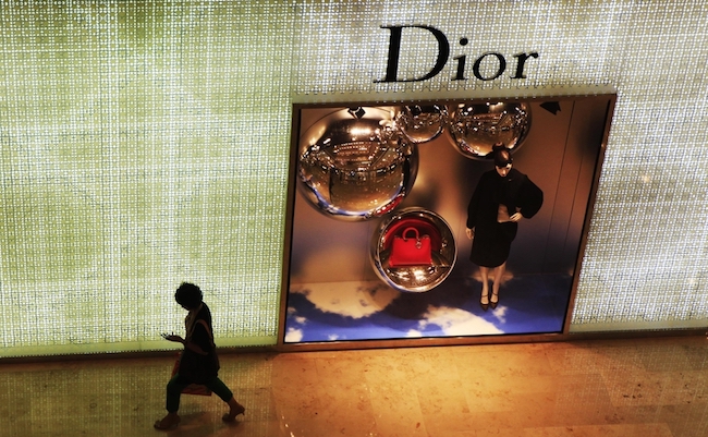 NANJING CHINA-September 8, 2013: pedestrians walk past a billboard at the Dior store in Nanjing, Xinjiekou. China has become the world's largest consumer market for luxury goods.