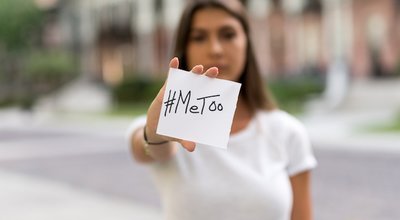 Beautiful Woman Holding a Card Arm Extended with #MeToo written on it