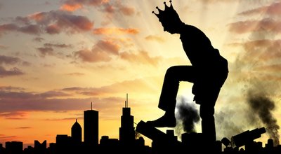 Big selfish man with a crown destroys the city on his way. Big Ego Concept