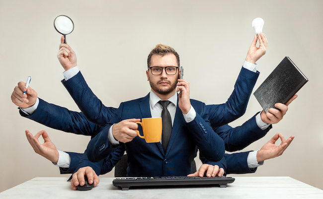 Businessman,With,Many,Hands,In,A,Suit.,Works,Simultaneously,With