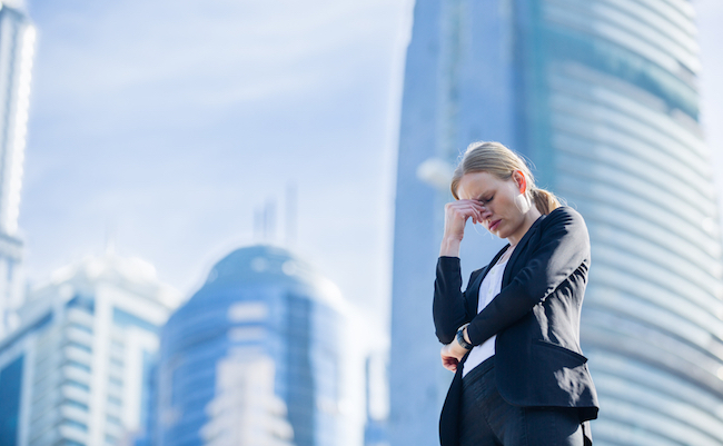 Stressed business woman in the city.