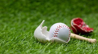 Baseball is in  egg shell for Easter Holiday on green grass