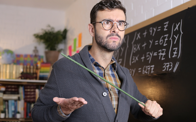 Old,Fashioned,Angry,Teacher,Holding,Stick,In,Classroom