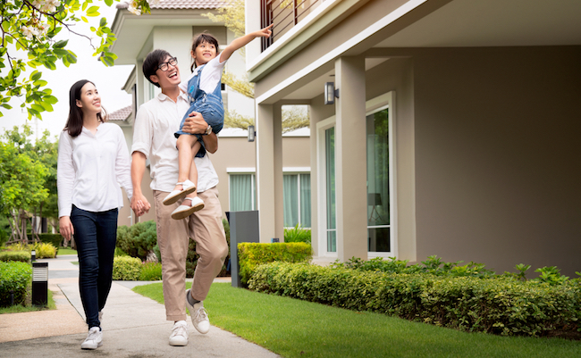 Beautiful,Family,Portrait,Smiling,Outside,Their,New,House,With,Sunset,