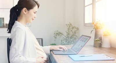 Asian pregnant woman working in the office.