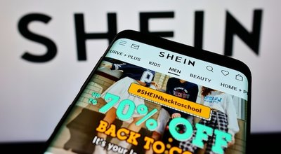 STUTTGART, GERMANY - Aug 14, 2021: Cellphone with online shop of Chinese e-commerce company Shein on screen in front of business logo  Focus on top-left of phone display