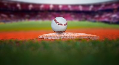 Baseball ball on baseball pad in main stadium green grass for baseball background.
