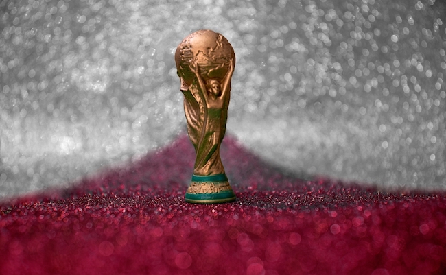 Vitória, Espírito Santo, Brazil - February 03, 2022 -  Copy of world cup trophy on background red, white and silver, qatar flag's color
