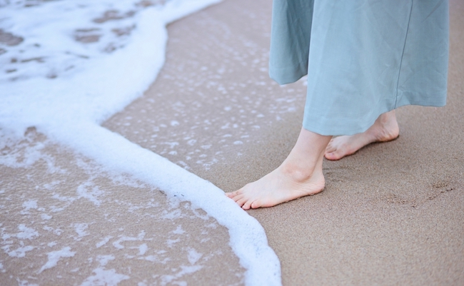Young,Japanese,Woman,Enjoying,A,Vacation,At,The,Beach