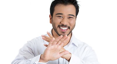 Closeup portrait, handsome, modest, young smiling man putting hands out, thank you for the compliment, but i'm not that good, isolated white background. Positive human emotion facial expression