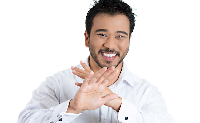 Closeup portrait, handsome, modest, young smiling man putting hands out, thank you for the compliment, but i'm not that good, isolated white background. Positive human emotion facial expression