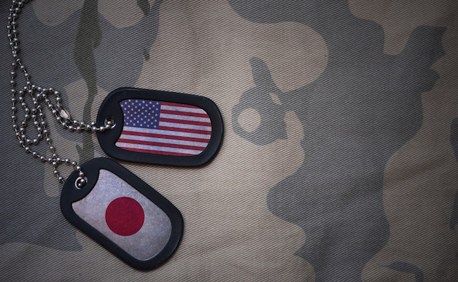 army blank, dog tag with flag of united states of america and japan on the khaki texture background. military concept