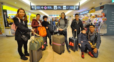 Photo of Asian family tourists from Thailand in front of the JR train sign in New Chitose Airport Sapporo, Japan January 21,2018