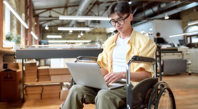Portrait,Of,Young,Male,Office,Worker,In,A,Wheelchair,Looking