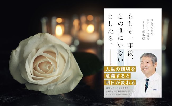 White rose and blurred burning candles on table in darkness, space for text. Funeral symbol