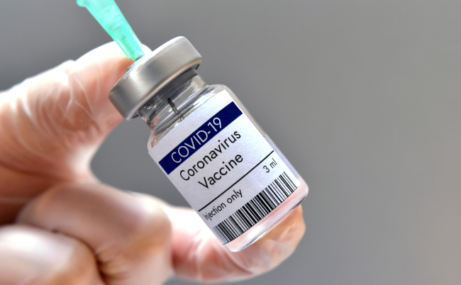 Coronavirus,Vaccine.,Doctor,Wearing,Gloves,Handles,Syringe,And,Vial,With