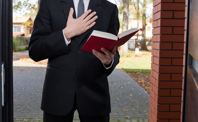 Jehovah’s,Witness,Standing,At,The,Door,And,Holding,Bible