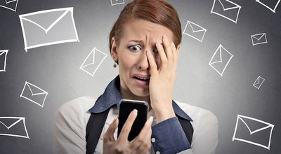 Upset stressed woman holding cellphone disgusted shocked with message she received isolated grey background. Funny looking human face expression emotion feeling reaction life perception body language