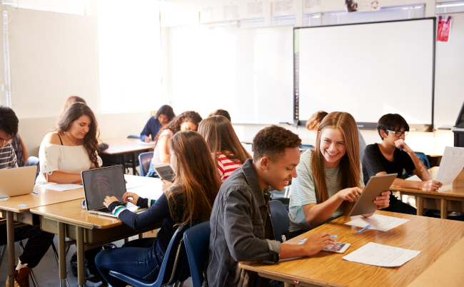 Wide,Angle,View,Of,High,School,Students,Sitting,At,Desks