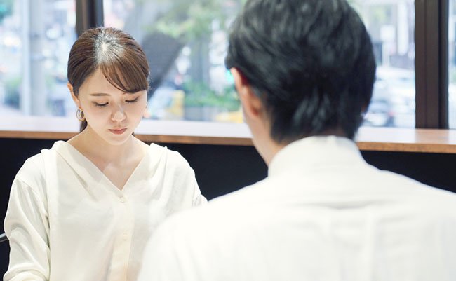 Woman and man facing each other.